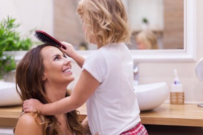 Niña peinando a su madre