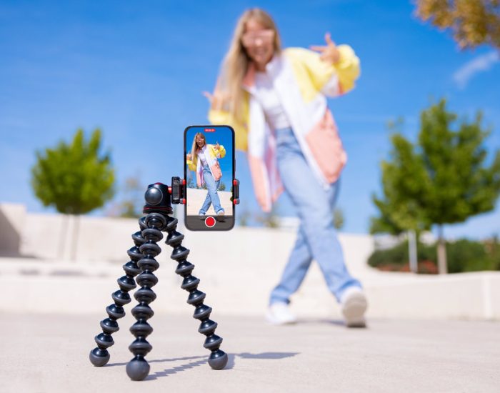 Teenage girl filming video of herself on mobile phone