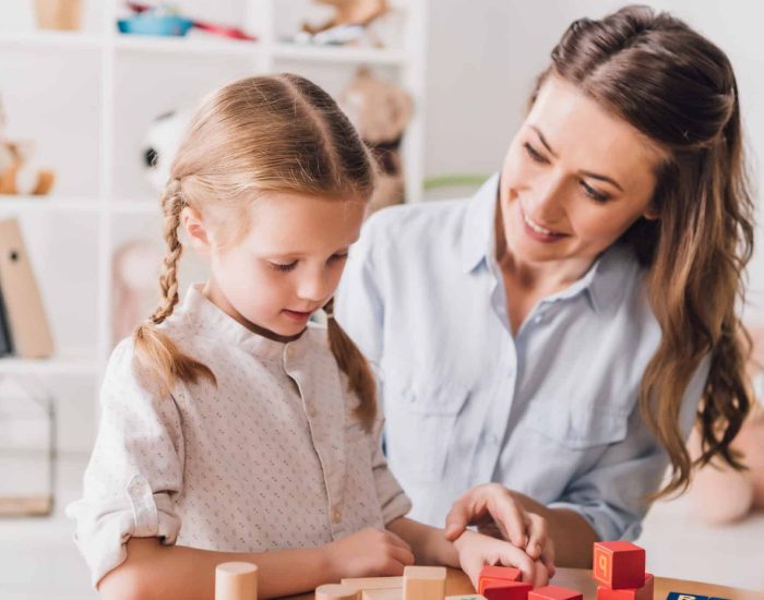 happy mother playing blocks with little child